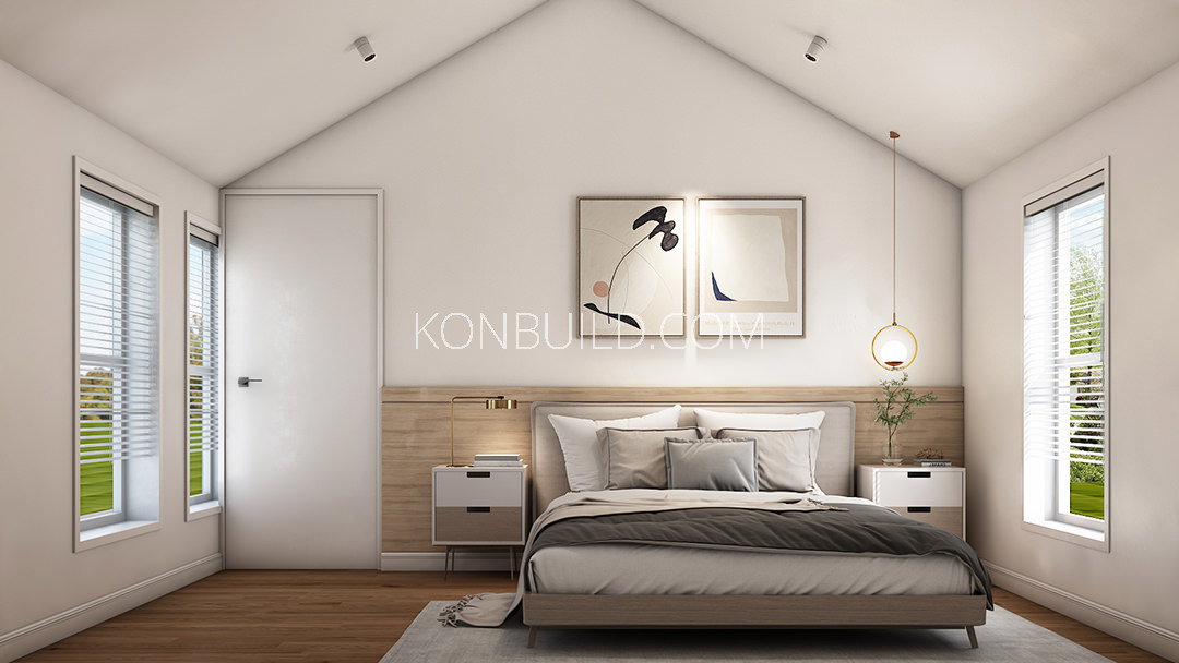 The interior of the modular home by konbuild that includes a bed.