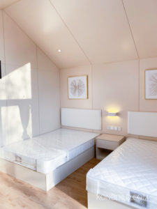 Simple bedroom in the interior of the Wood Wisper modular home.